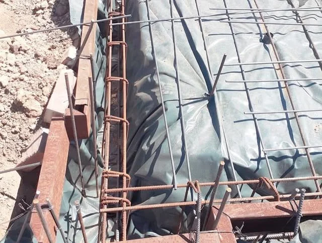 Mesh and reinforcing bars laid over damp proof membrane before the pour